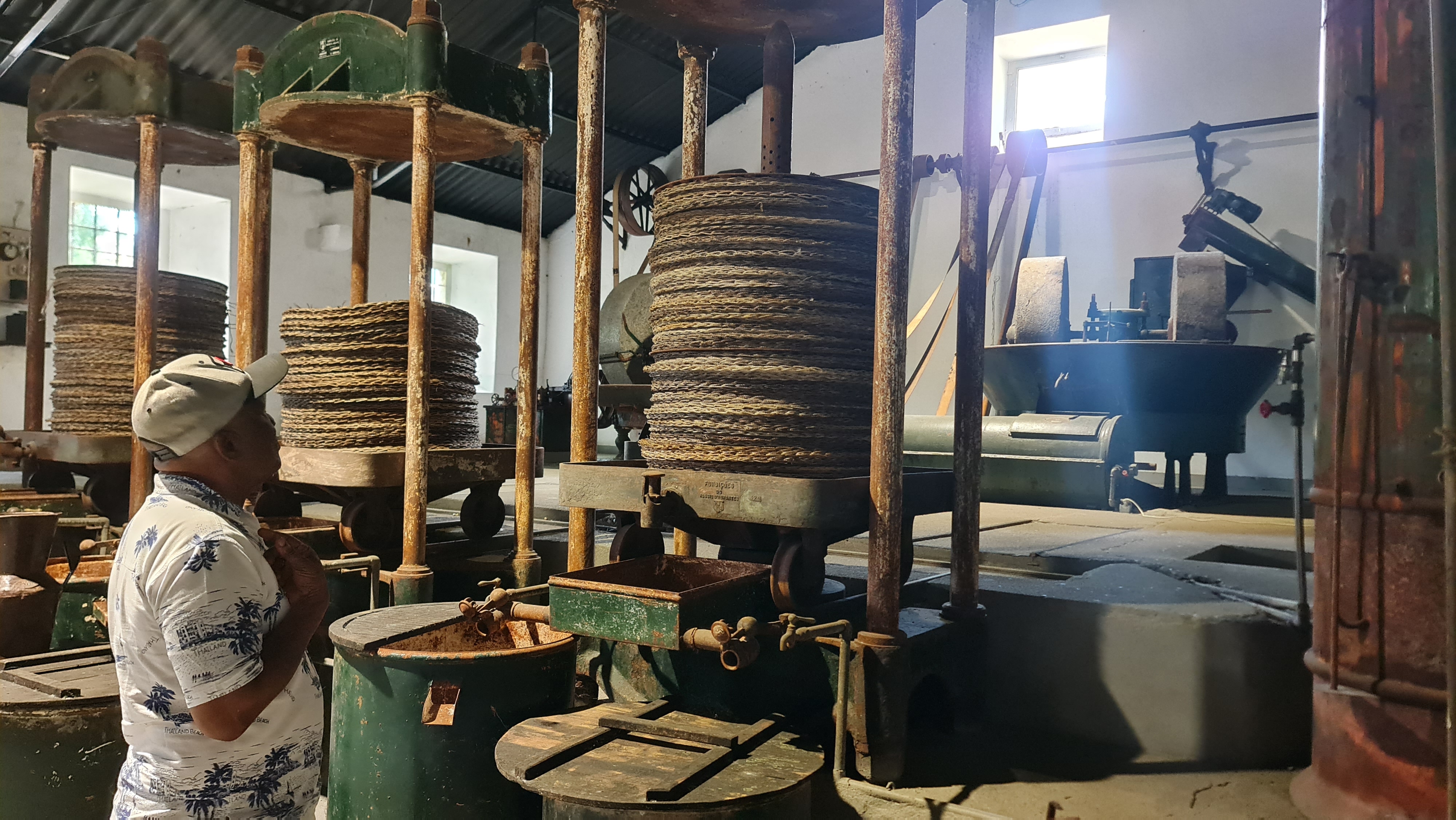 Man looking at an old olive oil press