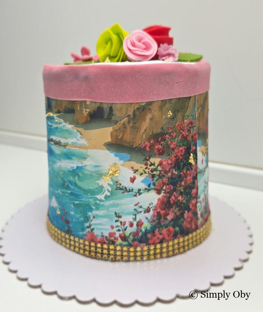 Wafer paper Algarve coastline cake with floral details and gold accents